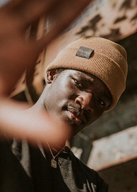 Tan brown woolen hat mockup psd on African American male model