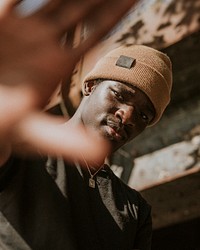 African American man wearing brown knit hat