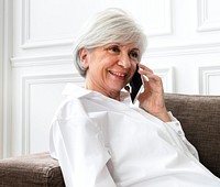 Senior woman talking on the phone at home