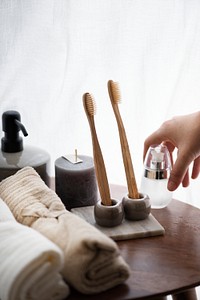 Aesthetic bathroom setting with environmental toothbrushes and scented candle