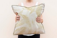 Woman holding a patterned cushion