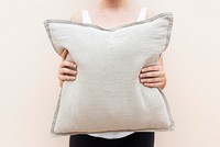 Woman holding a beige cushion