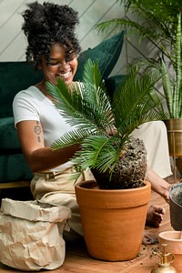Woman repotting plants in the new normal