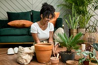 Woman repotting plants in the new normal