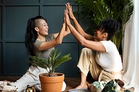 Women repotting plants at home in the new normal