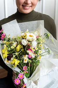 Woman carrying a bouquet of flowers