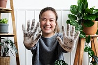 Woman showing her soiled gardening glove