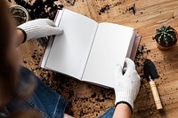 Empty book mockp psd in the hands of a gardener