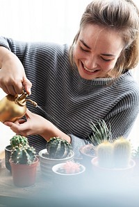 Woman tending and caring for her cacti