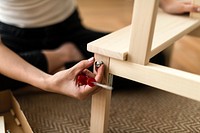 Woman assembling a diy chair from scratch