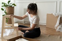 Woman assembling a diy chair from scratch