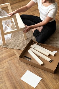 Woman assembling a diy chair from scratch