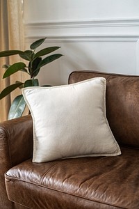 White cushion on a leather couch