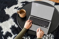 Woman working from home on a laptop with empty screen