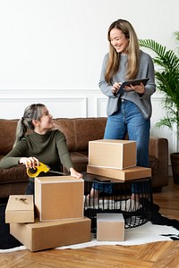 Small business friend partners packing product parcels for delivery