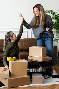 Small business friend partners packing product parcels for delivery