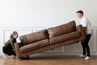 Couple moving a sofa in a new home