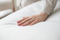 Hand on a soft duvet