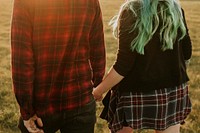 Couple walking and holding hands outdoors