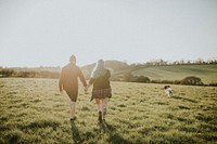 Couple walking and holding hands outdoors