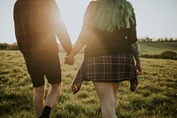 Couple walking and holding hands outdoors