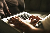 Tattooed alternative man using a laptop