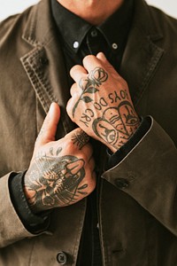 Man with tattooed hands holding his shirt. 2 OCTOBER 2020 - CHIPPENHAM, UK