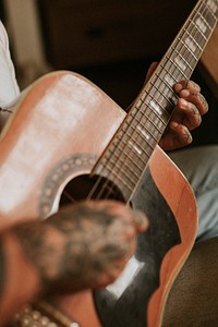 Artist playing an acoustic guitar