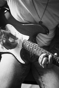 Alternative man playing the electric guitar in a studio