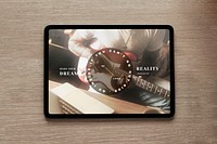 Tablet screen mockup psd flatlay on a wooden table