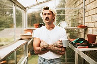 Blonde man his his greenhouse 