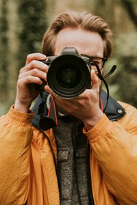 Photographer man taking a photo outdoor traveling