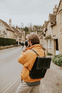 Photographer man taking photos in the village