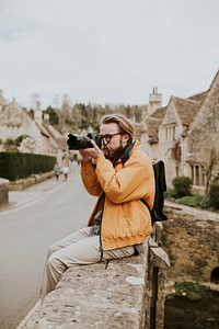 Photographer man taking photos in the village