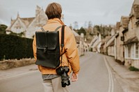 DSLR camera with strap hanging on photographer’s shoulder