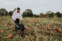 Woman at a pumpkin patch before Halloween