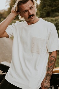 Man in white t-shirt with design space standing by the countryside