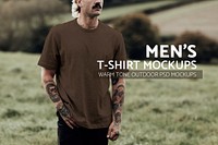 Attractive man in brown t-shirt with design space standing in countryside