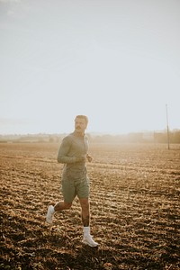 Active man in sportswear running in the countryside