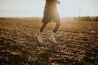 Active man in sportswear running in the countryside