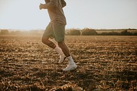 Active man in sportswear running in the countryside