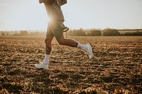 Active man in sportswear running in the countryside