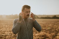 Cool urban man listening to music while working out