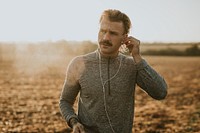 Cool urban man listening to music while working out