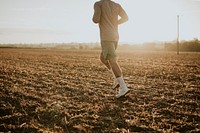 Active man in sportswear running in the countryside