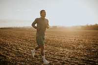 Active man in sportswear running in the countryside