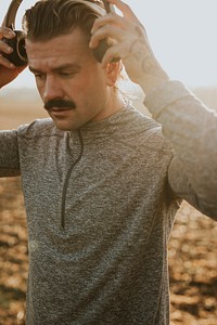 Cool man listening to music wearing wireless headphones