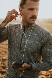 Cool urban man listening to music while working out