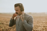 Cool man listening to music wearing wireless headphones