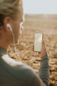 Man holding phone with empty screen and design space